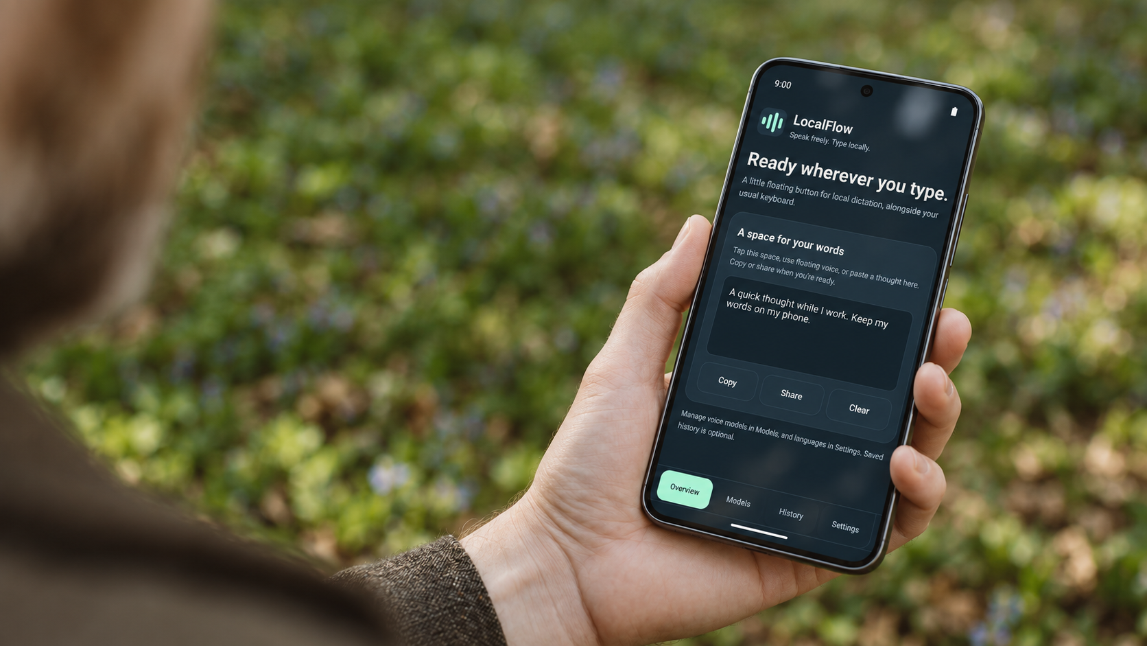 A hand holding an Android phone with the LocalFlow interface outdoors. Campaign illustration.